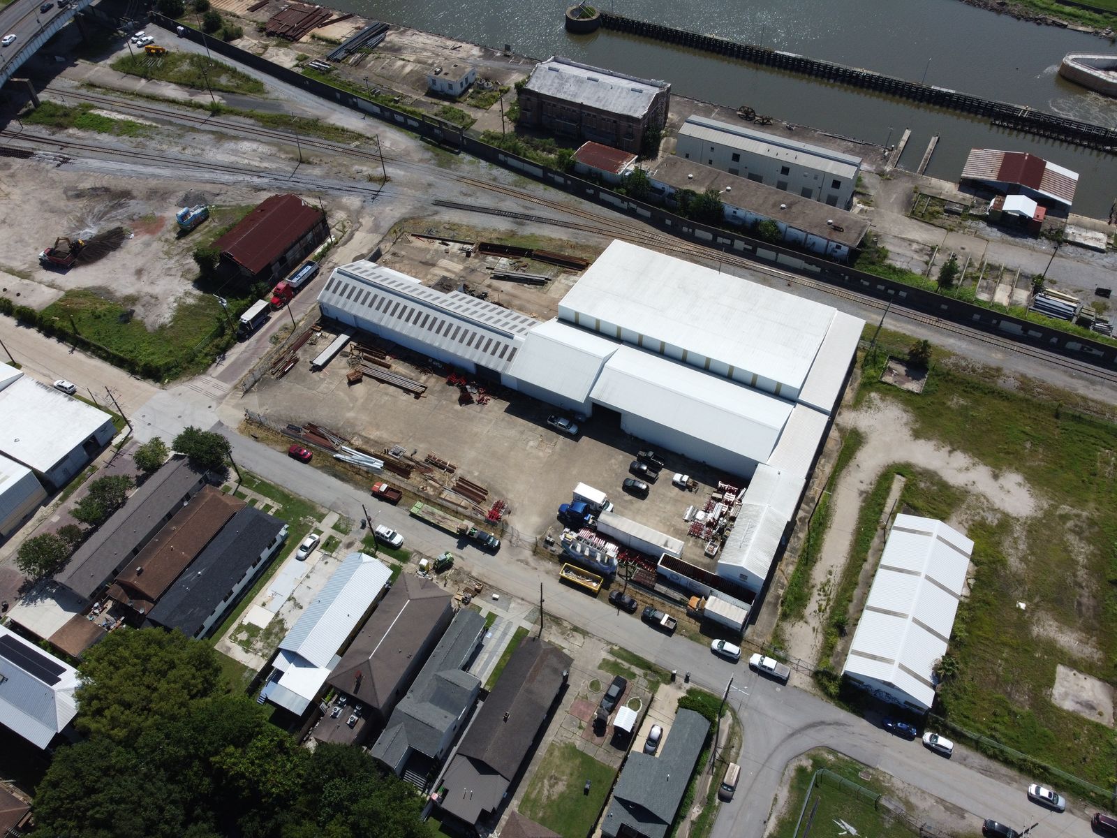 Aerial view of the white warehouse at 1435 Japonica Street and its front lot, with the smaller building at 1333 Japonica Street to the right.