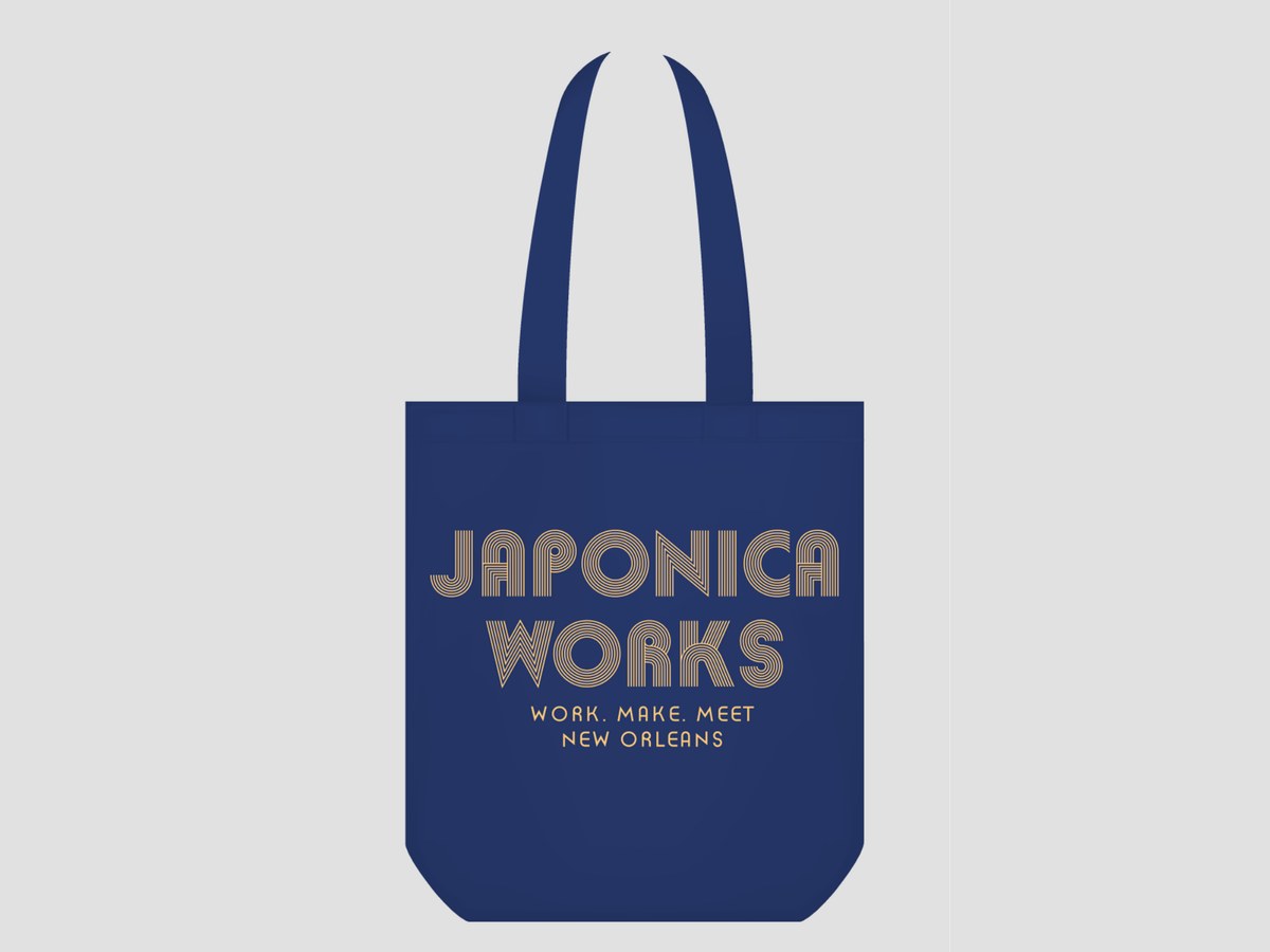 Navy tote bag with the Japonica Works logo, Work. Make. Meet. and New Orleans.
